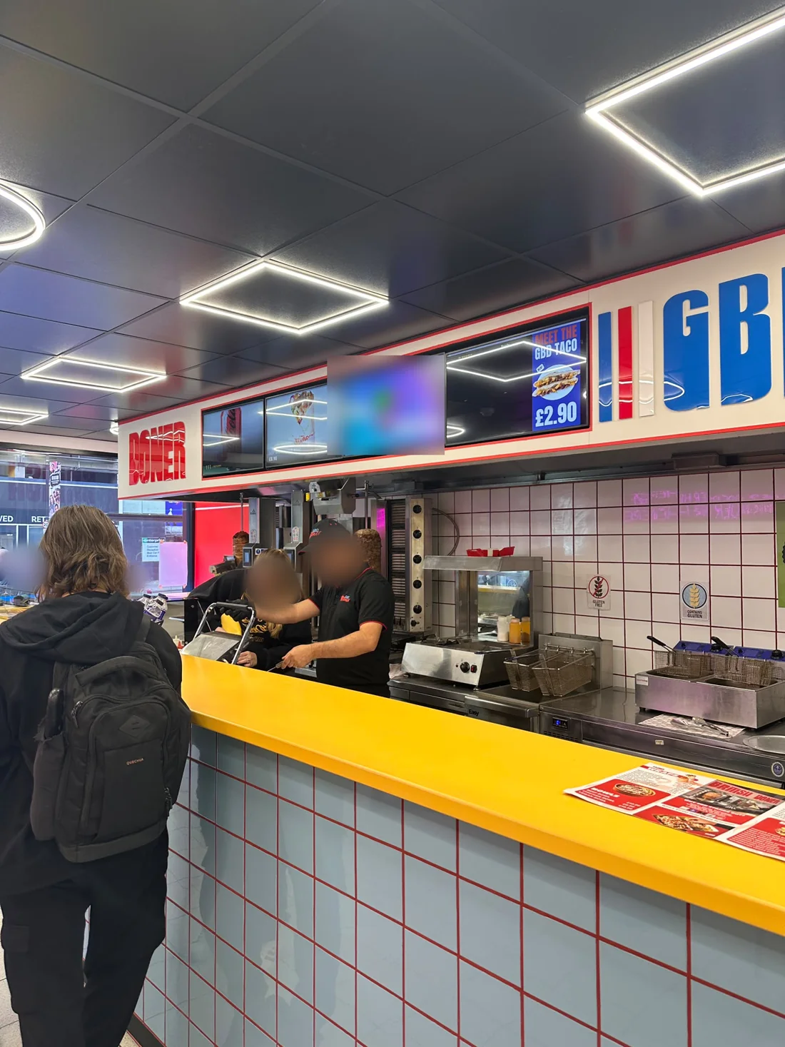 The Great British Doner counter with digital menu boards above it, showing the GBD Taco at £2.90